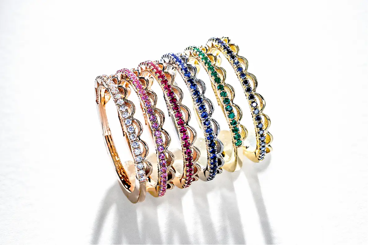 A stack of TACORI wedding bands, each featuring a different color gem