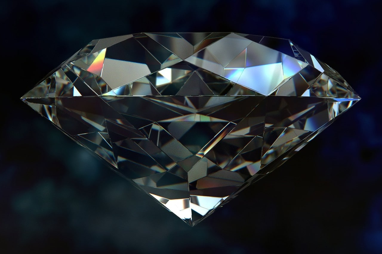 Close up image of a round cut diamond against a dark background