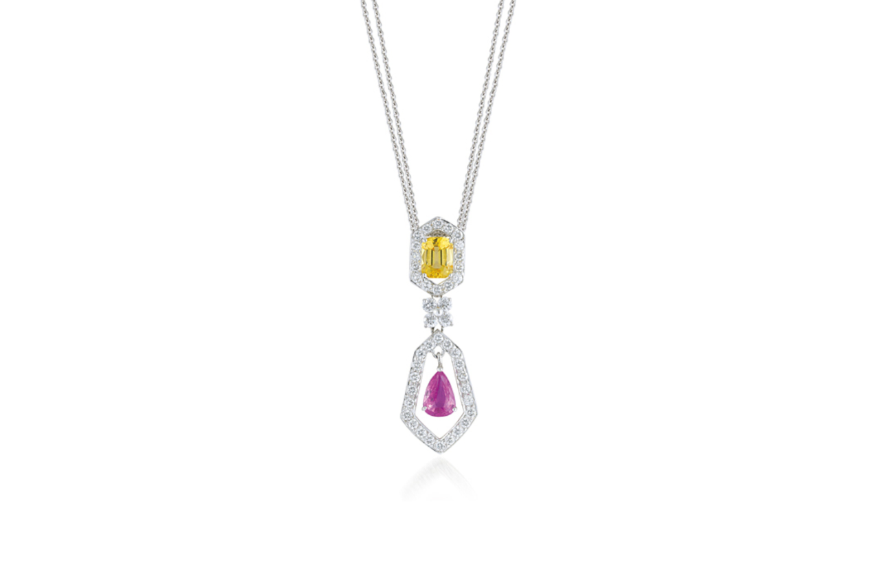 A colorful diamond necklace with a yellow stone at the top and a purple stone at the bottom.