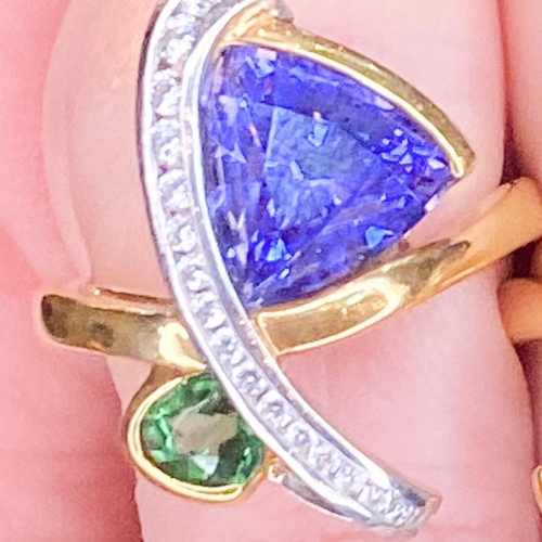2.61ct Tanzanite and .46ct tsavorite with .20cts of diamonds.  18k yellow gold