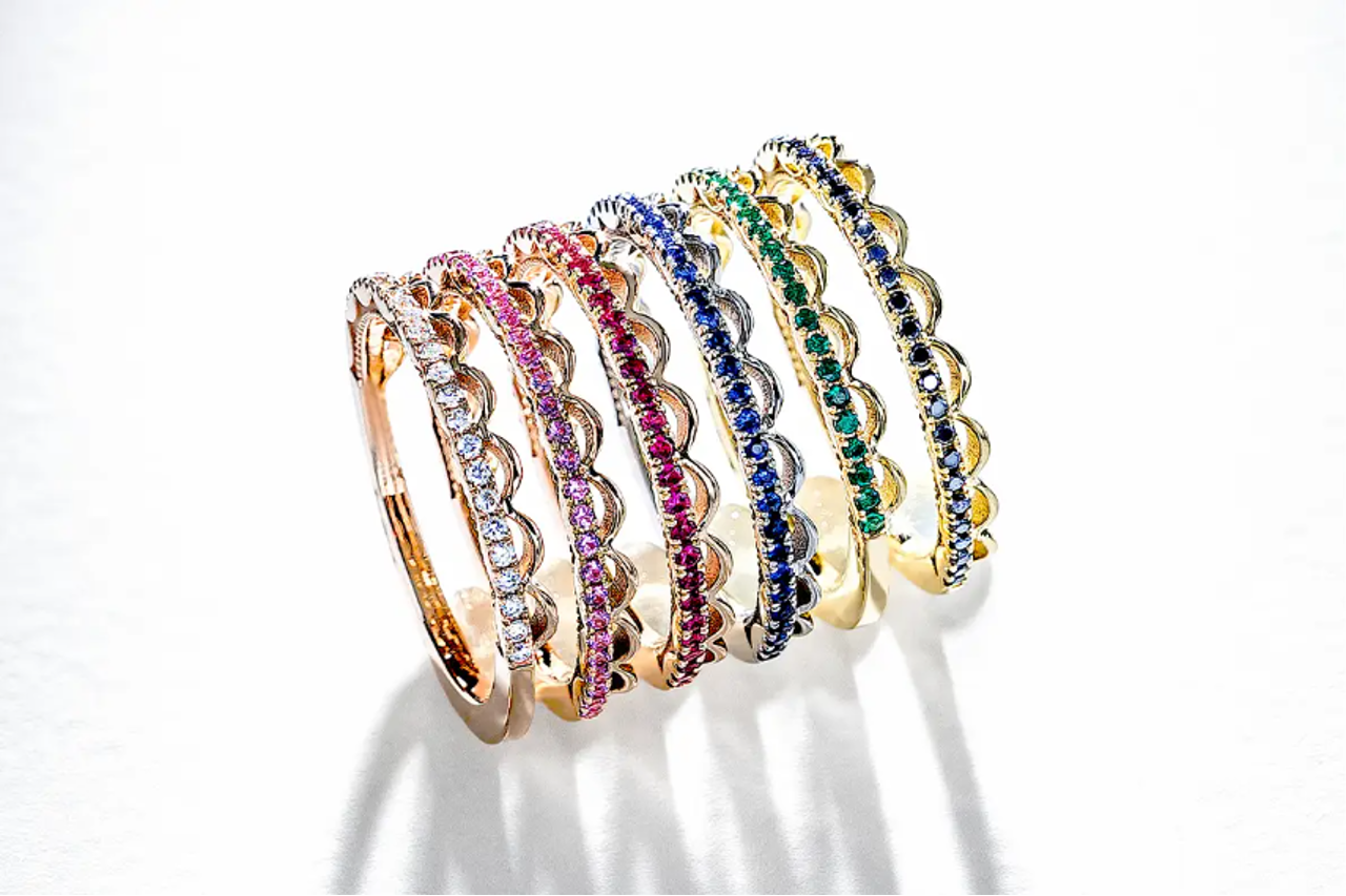 A stack of Tacori wedding bands, each featuring a different color gem A stack of Tacori wedding bands, each featuring a different color gem